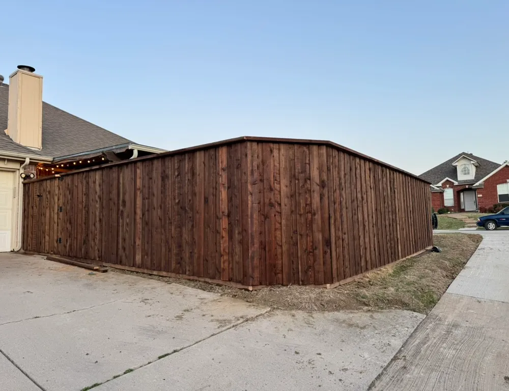 Natural cedar board-on-board fence with trim and a flat top cap